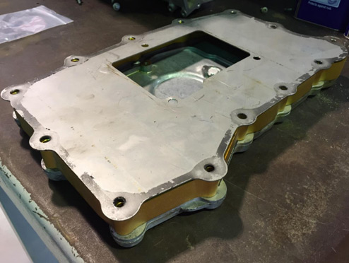 Install the aluminum baffle plate — photo 1